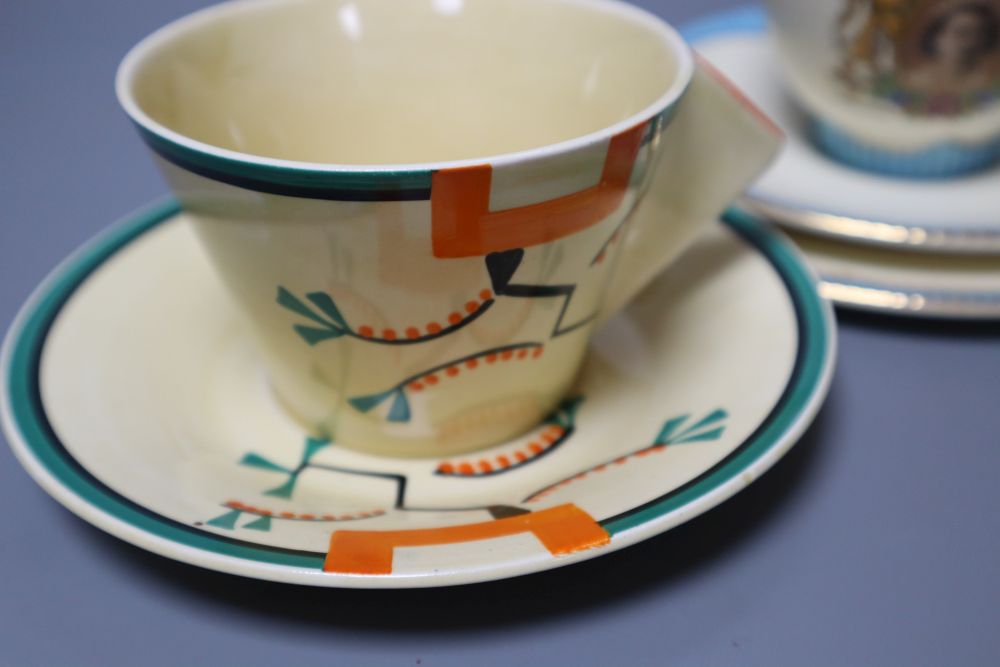 A Clarice Cliff Ravel pattern tea cup and saucer and a Queen Elizabeth II coronation trio, 1953